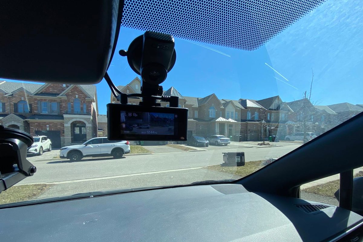 Dash cam mounted at the windshield with the wiring hidden in the headliner